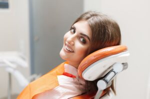 a smiling patient in a dentist chair