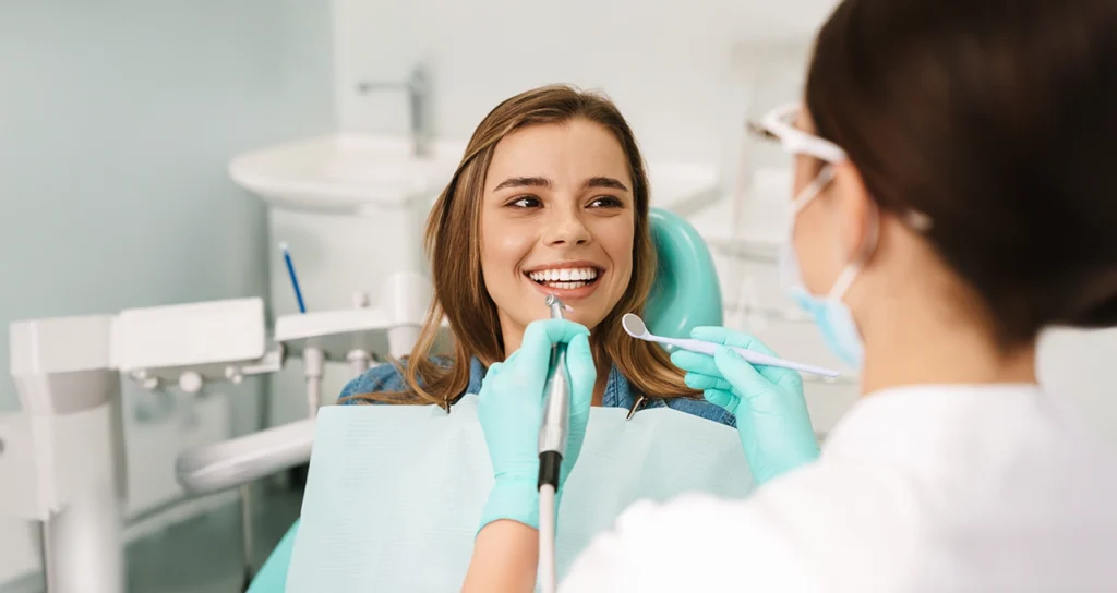 A smiling patient receiving a routine dental checkup, highlighting the importance of preventive care for a healthy smile.