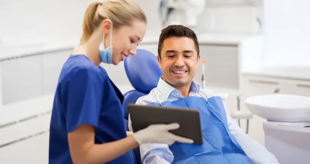 Dentist reviewing a treatment plan with a patient.