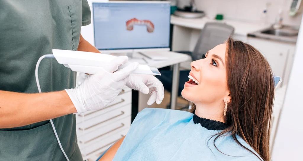 Digital dental scan being performed on a smiling patient.